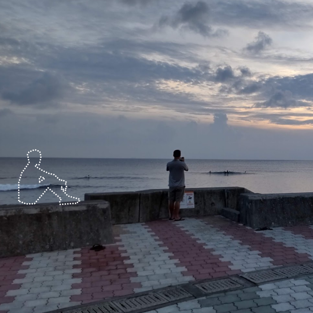 海の夕日、防波堤に座っている人の点々アウトライン